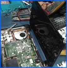 laptop on workbench being repaired